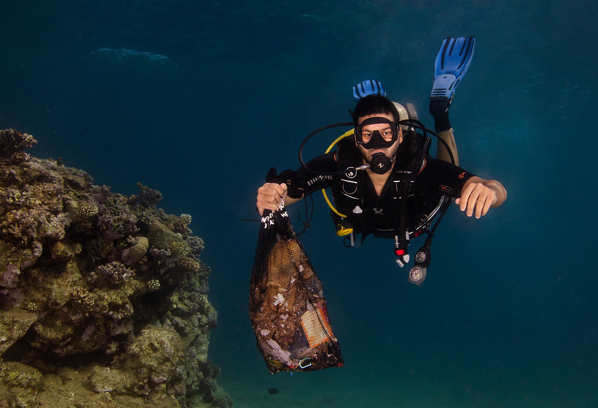 Diver cleaning debris underwater