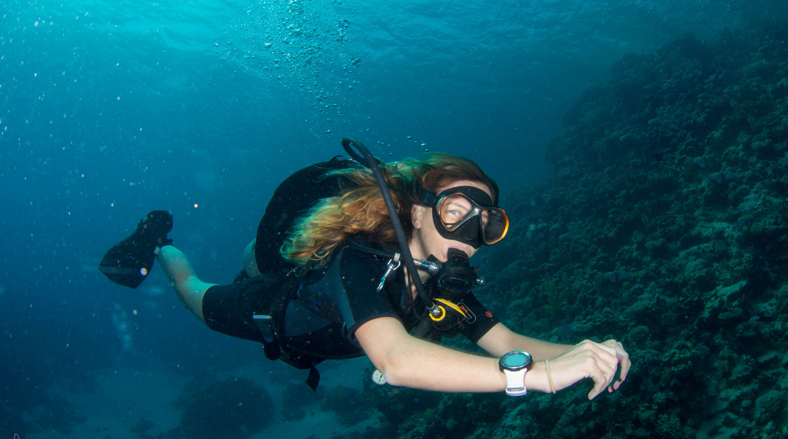 female diver exploring the reef