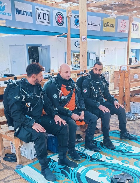Scuba Seekers instructor debriefing a group of divers in their gear at the dive centre
